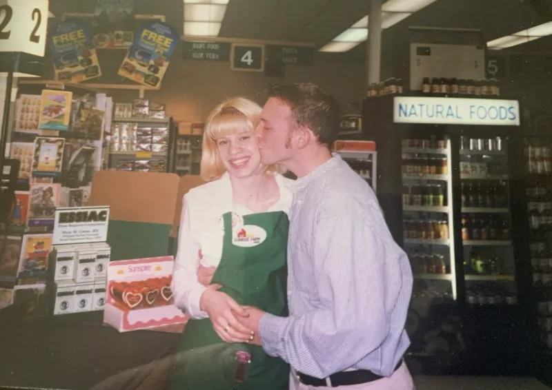 Aaron Wise kissing Jackie on the cheek at Sunrise Health Foods